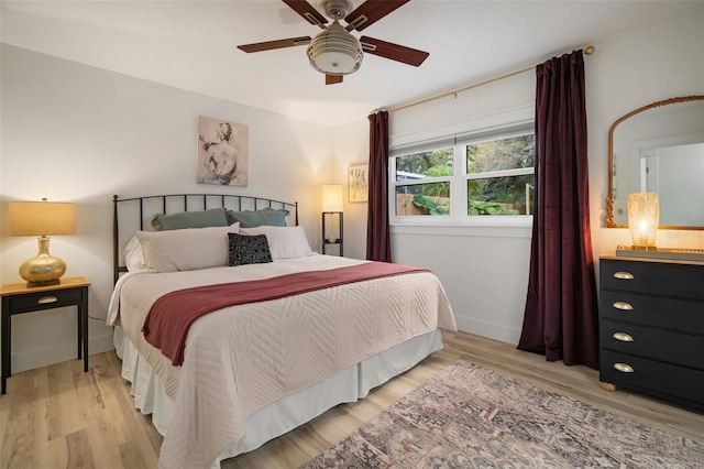 bedroom with ceiling fan and light hardwood / wood-style floors