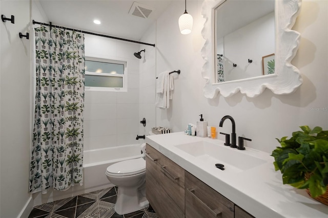 full bathroom with tile patterned floors, shower / bath combo with shower curtain, vanity, and toilet