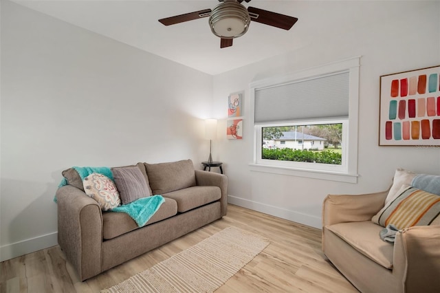 living room with ceiling fan and light hardwood / wood-style flooring