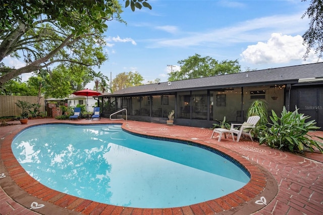 view of swimming pool with a sunroom