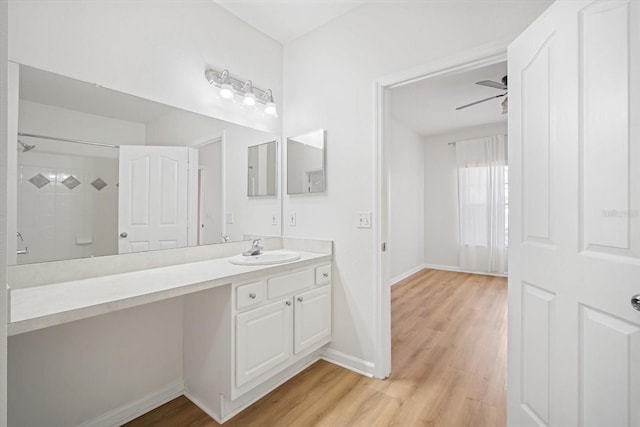 bathroom featuring a shower, ceiling fan, vanity, and hardwood / wood-style flooring