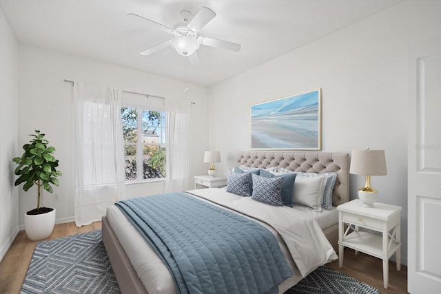 bedroom with wood-type flooring and ceiling fan