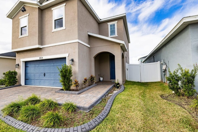 view of front of property with a front yard and a garage