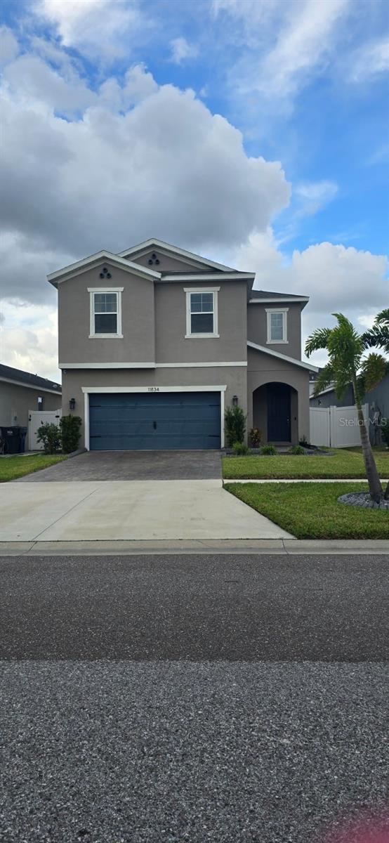 front of property with a front yard and a garage