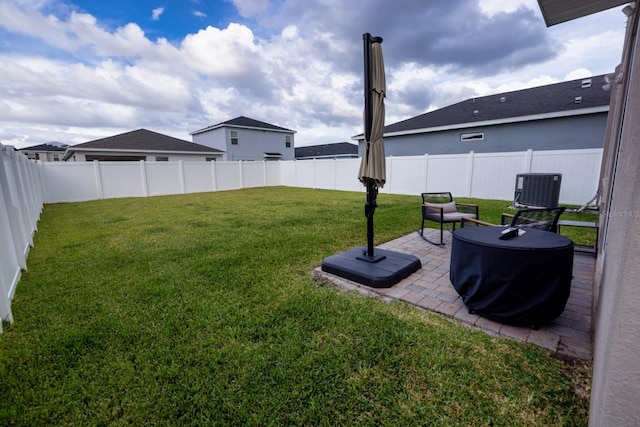 view of yard featuring central AC and a patio area