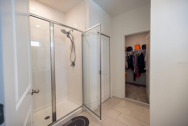 bathroom featuring tile patterned flooring and an enclosed shower