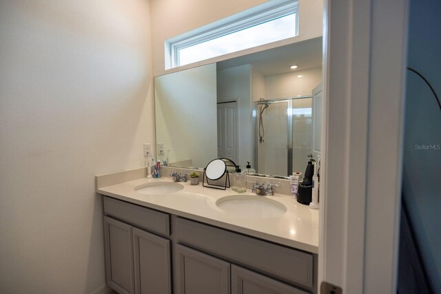 bathroom with vanity and a shower with shower door