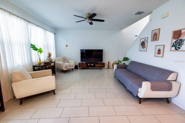 tiled living room with ceiling fan