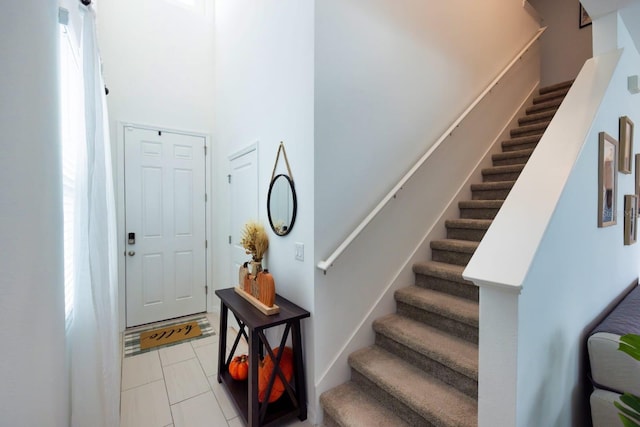 foyer entrance with light tile patterned floors