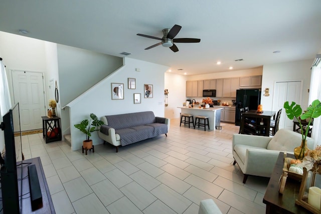 living room featuring ceiling fan and light tile patterned flooring