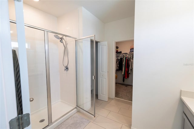 11834 Brighton Knoll Loop, Riverview, FL 33579 - bathroom with a shower stall, vanity, a spacious closet, and tile patterned floors