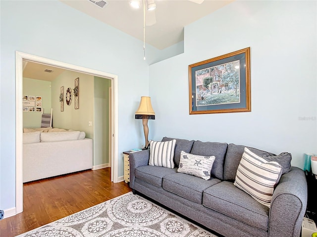 living room featuring hardwood / wood-style floors and ceiling fan