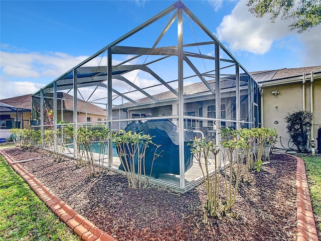 view of side of home with a lanai