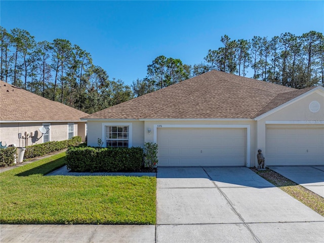 ranch-style home with a garage and a front lawn