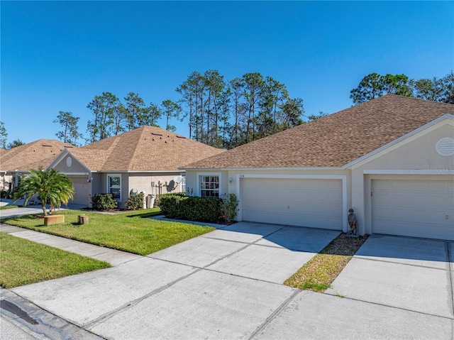 ranch-style home with a garage and a front lawn