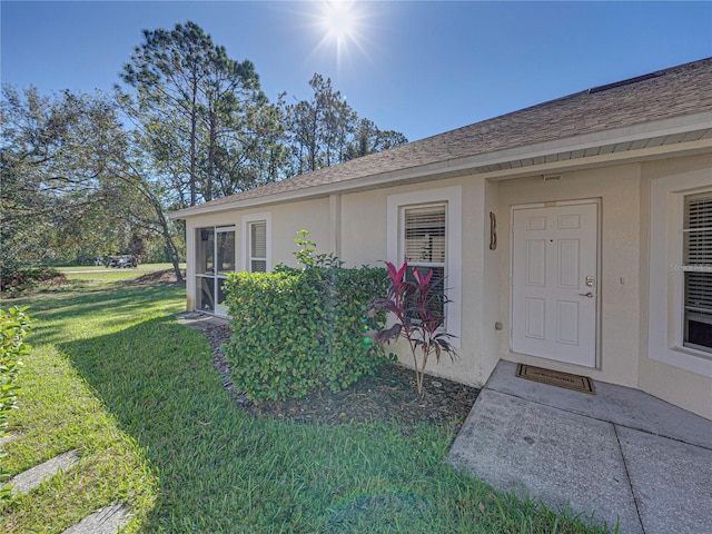 property entrance featuring a yard