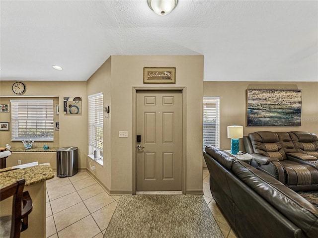 tiled foyer featuring a textured ceiling