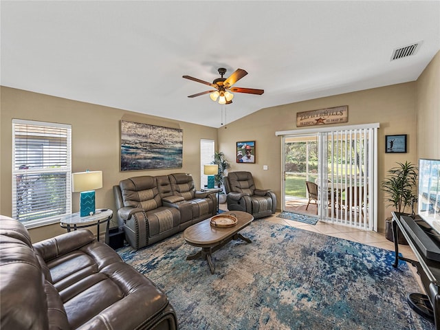 tiled living room with ceiling fan and vaulted ceiling