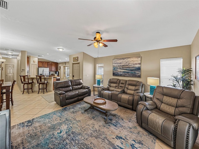 living room with ceiling fan and light tile patterned floors