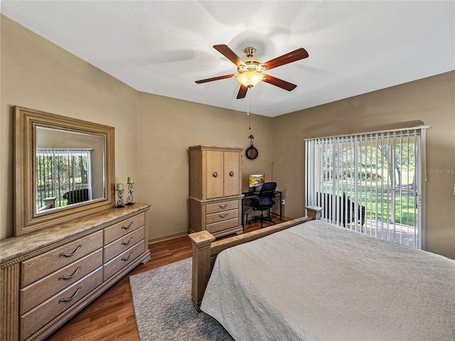 bedroom with ceiling fan, dark wood-type flooring, and multiple windows