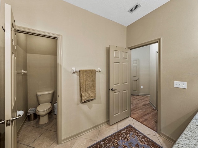 bathroom featuring hardwood / wood-style flooring and toilet