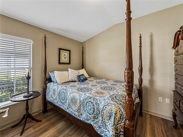 bedroom featuring wood-type flooring and vaulted ceiling