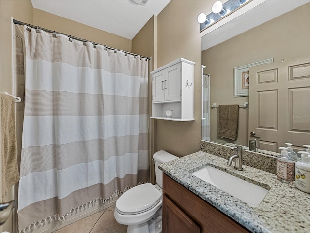 bathroom featuring tile patterned floors, curtained shower, vanity, and toilet