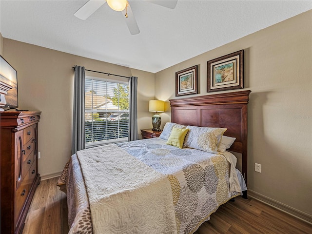 bedroom with ceiling fan and dark hardwood / wood-style flooring