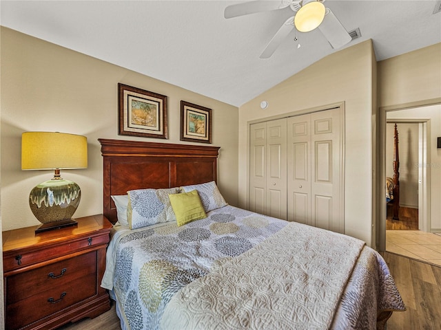 bedroom featuring hardwood / wood-style floors, a closet, vaulted ceiling, and ceiling fan