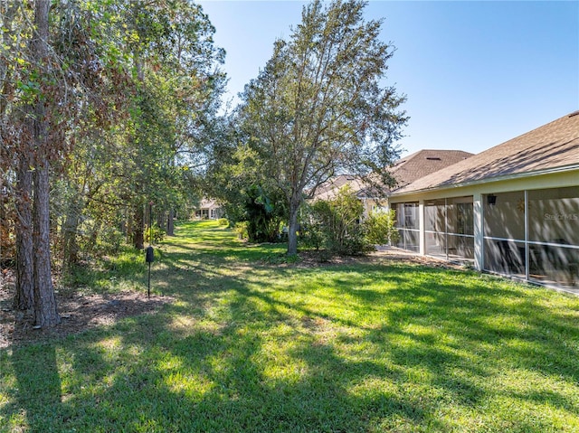 view of yard featuring a sunroom