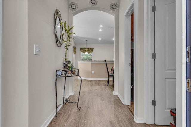 hallway with light hardwood / wood-style flooring