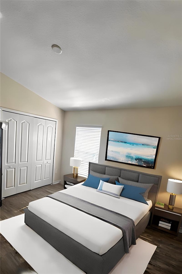 bedroom featuring dark hardwood / wood-style flooring, a closet, and lofted ceiling