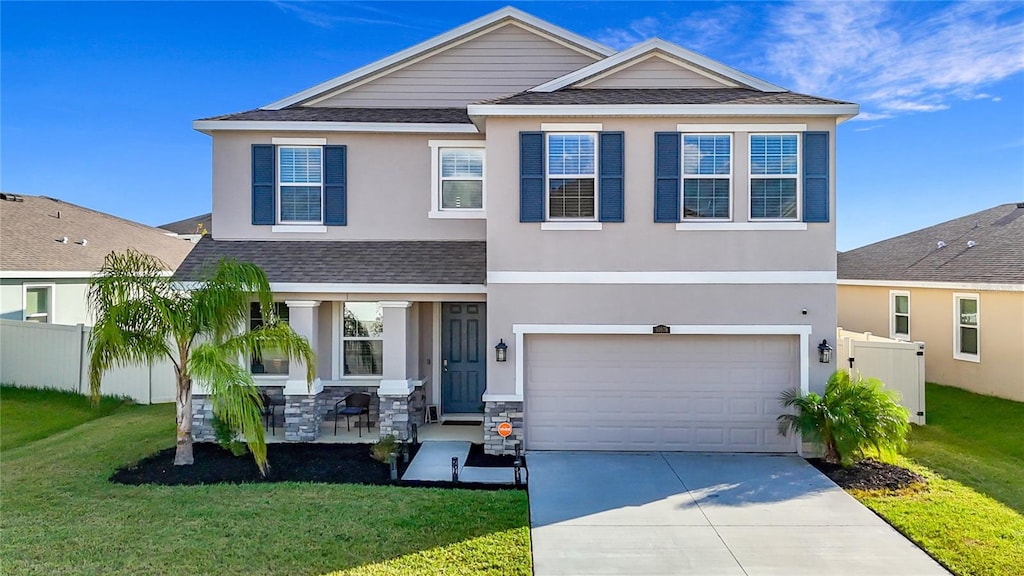 view of front of property featuring a garage and a front lawn