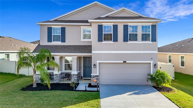 view of front of property featuring a garage and a front lawn