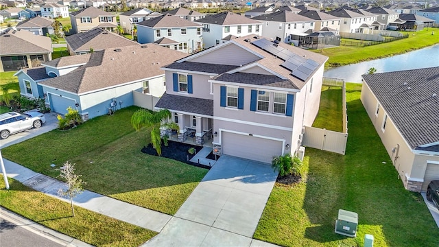 birds eye view of property with a water view