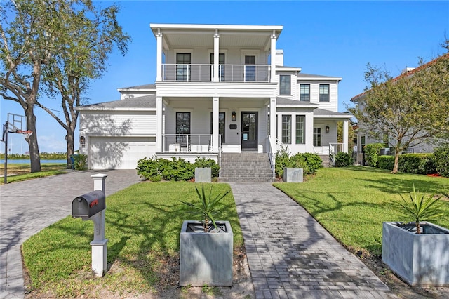 view of front of house featuring a front lawn, a porch, a balcony, and a garage