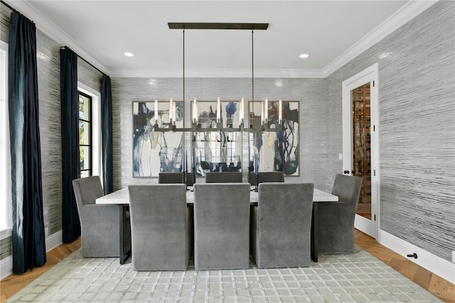 dining space with light hardwood / wood-style flooring and ornamental molding