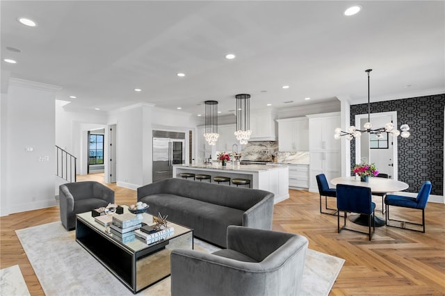 living room with light parquet flooring, crown molding, and an inviting chandelier