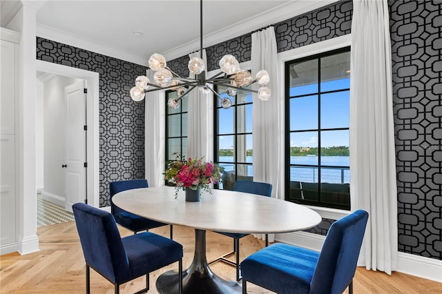 dining room with light parquet floors, a water view, and ornamental molding