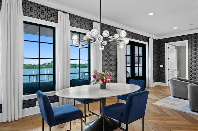 dining room with light parquet flooring, a water view, crown molding, and a notable chandelier