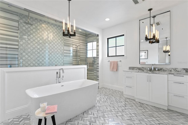 bathroom with vanity, an inviting chandelier, and independent shower and bath