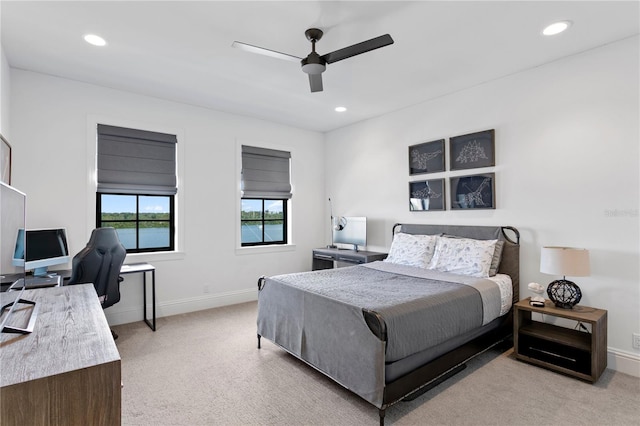 bedroom with light carpet and ceiling fan