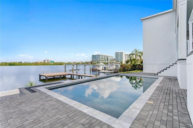 view of pool featuring a boat dock and a water view