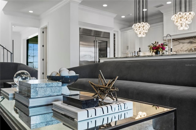 interior space featuring sink, crown molding, and an inviting chandelier