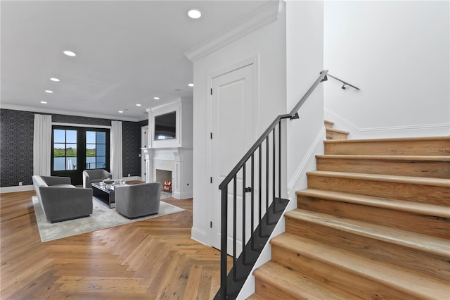 living room featuring french doors, light parquet floors, and crown molding