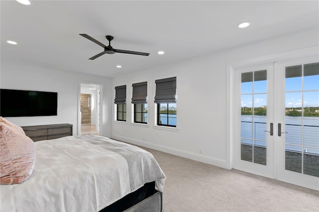 carpeted bedroom with ceiling fan, multiple windows, access to outside, and french doors