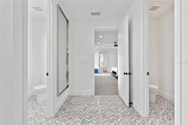 bathroom with ceiling fan and toilet