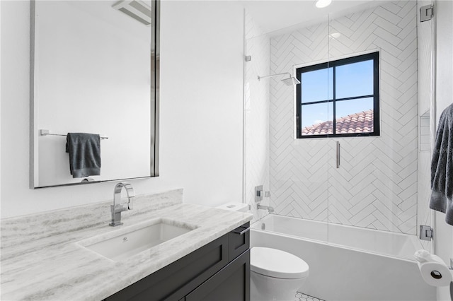 full bathroom featuring vanity, toilet, and tiled shower / bath