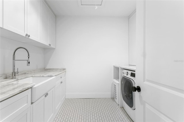 washroom featuring cabinets, separate washer and dryer, sink, and light tile patterned floors