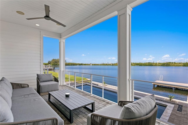 balcony featuring ceiling fan, a water view, and an outdoor hangout area